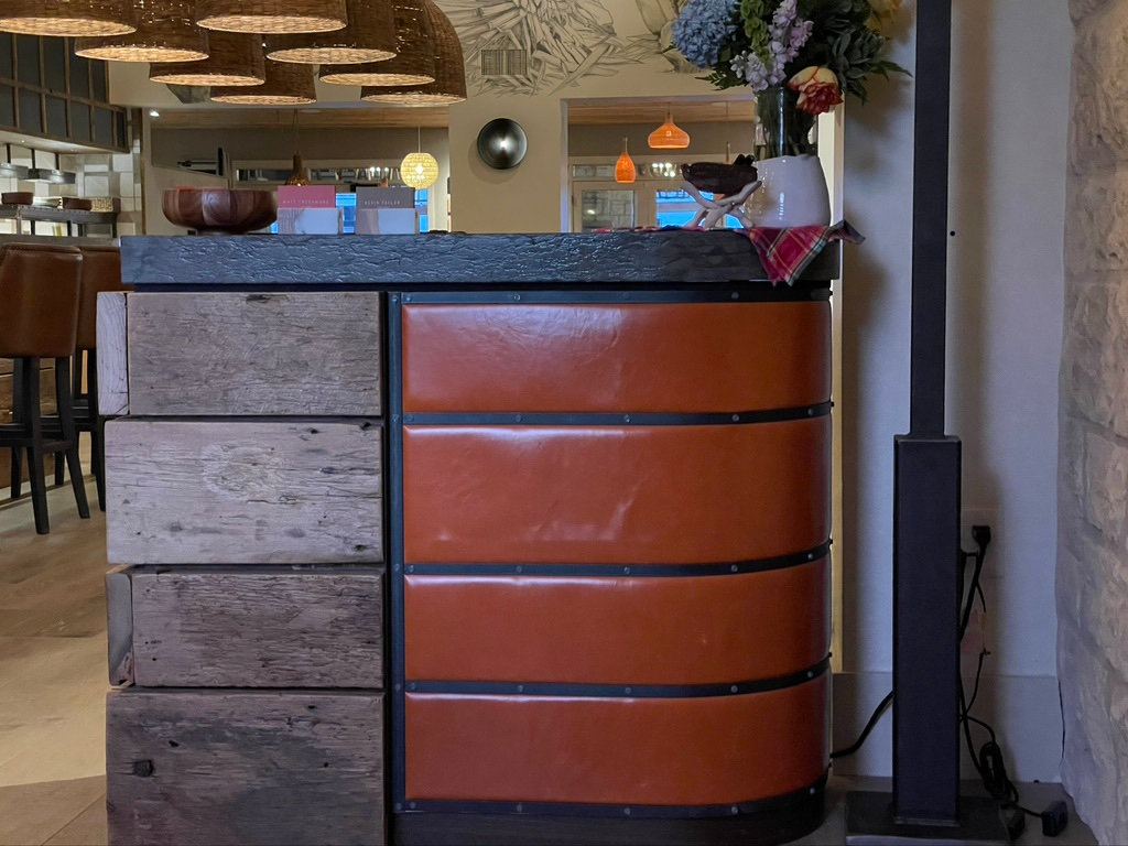 Bar front clad in orange panels and metal, built in SunRay's shop